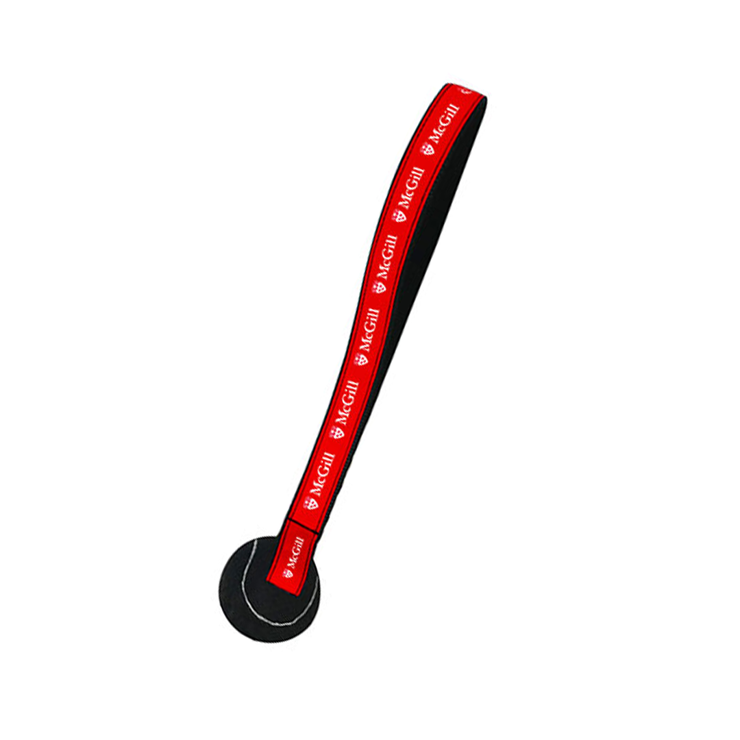 Tug toy featuring a nylon strap with red ribbon printed with the McGill logo and black tennis ball attached at the end